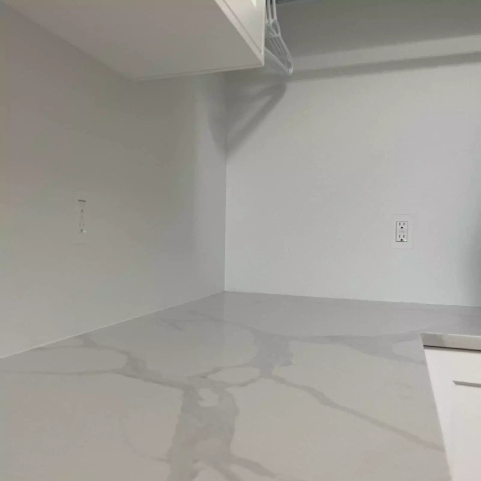 Two 1-gang flush-mounted Decora GFCI outlets on painted white backsplash walls with a marble countertop